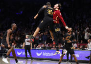 Cleveland Cavaliers forward Isaac Okoro (35) and forward Cedi Osman, center right, celebrate after defeating the Brooklyn Nets, Thursday, March 23, 2023, in New York. (AP Photo/Noah K. Murray)