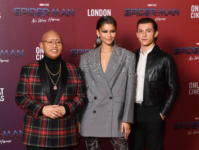 From left to right: John Balaton, Zendaya Coleman, and Tom Holland pose for photos on the red carpet at their film's premiere