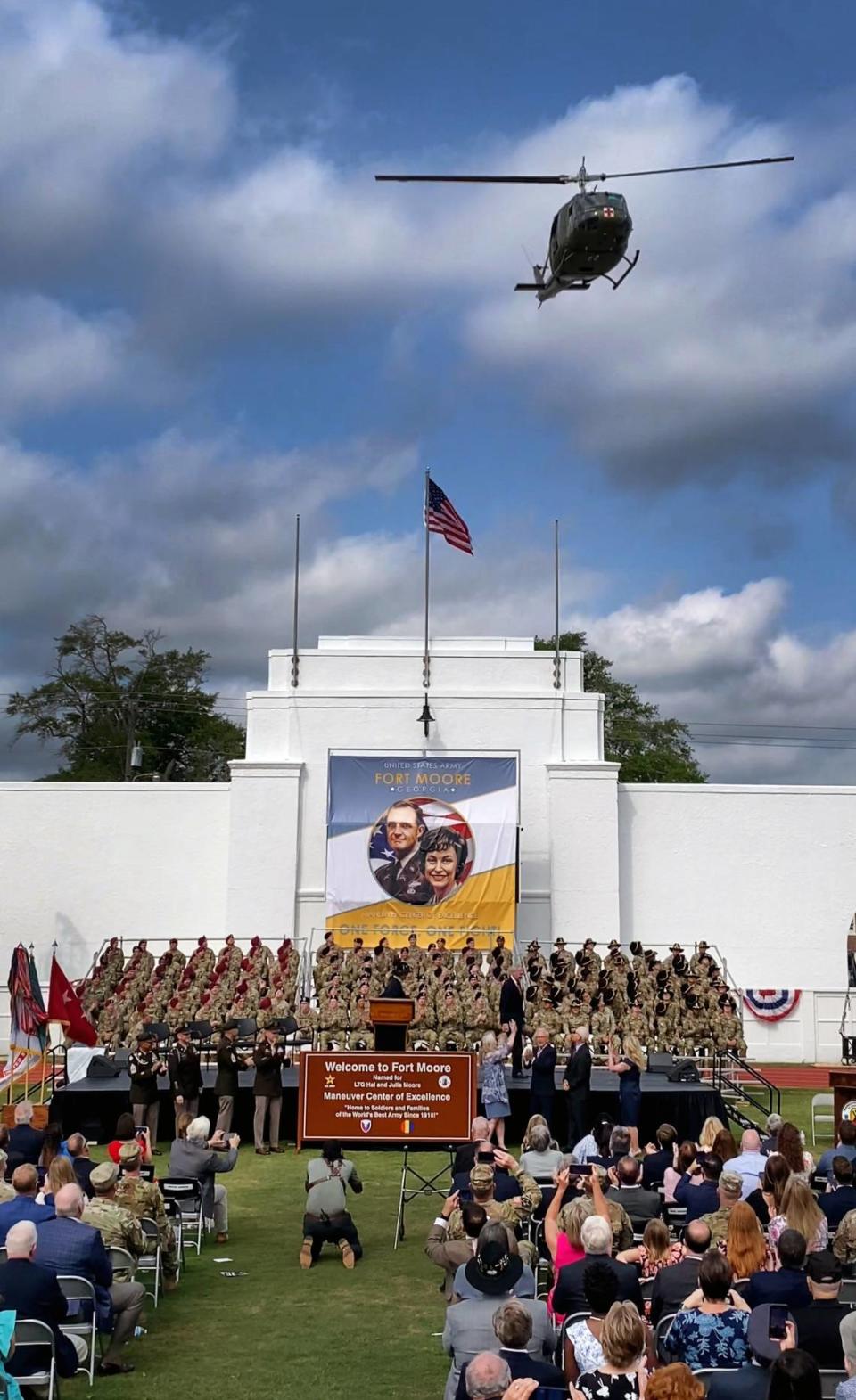 A Bell UH-1 helicopter, commonly known as a “Huey,” flies over Doughboy Stadium after the new Fort Moore sign was unveiled Thursday morning. Fort Benning was redesignated as Fort Moore during the ceremony. 05/11/2023