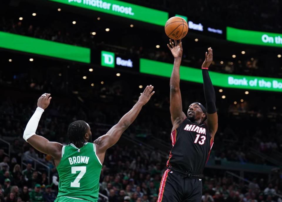 Miami Heat center Bam Adebayo shoots against Boston Celtics guard Jaylen Brown in the first quarter during Game Two of the Eastern Conference first round series on Wednesday at TD Garden in Boston. Adebayo and the Heat set a franchise record for threes made in a playoff game, shooting 23 of 43 from behind the arc in the 111-101 win. David Butler II/USA TODAY Sports