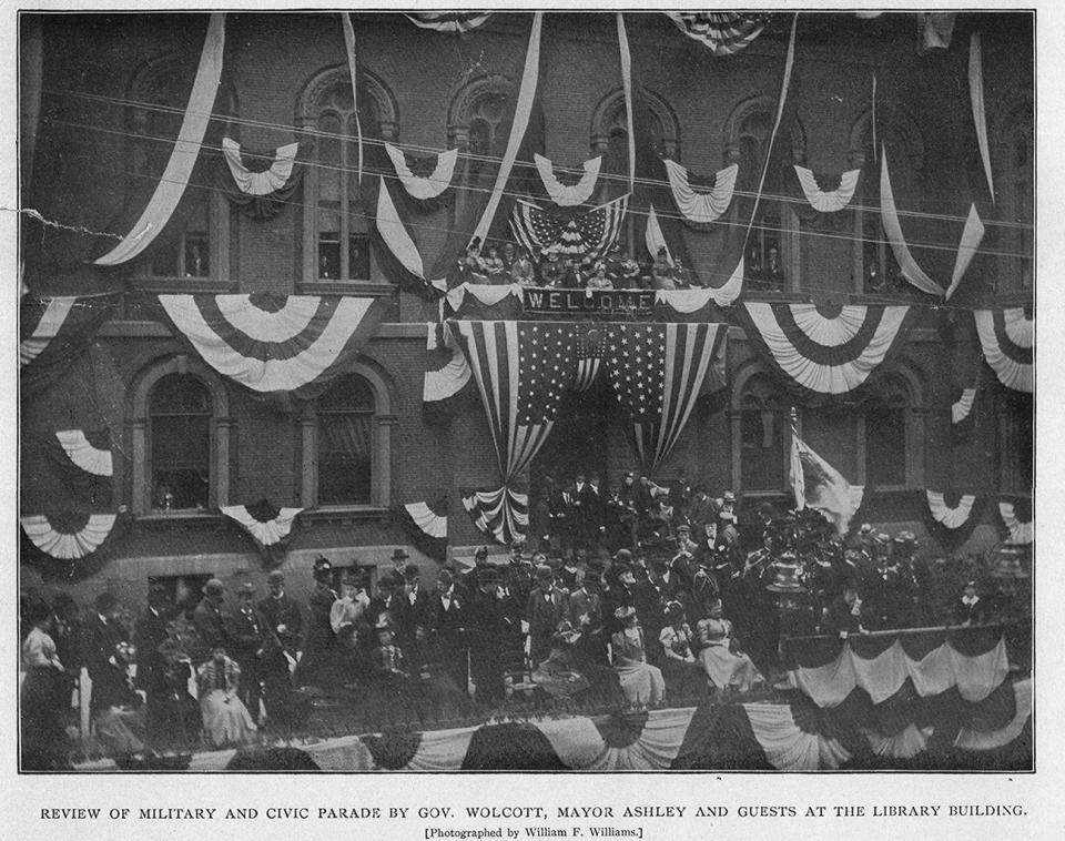 New Bedford's Semi-Centennial celebration includes a review of the military and civic parade by Gov. Wolcott, Mayor Ashley and guests at the library.