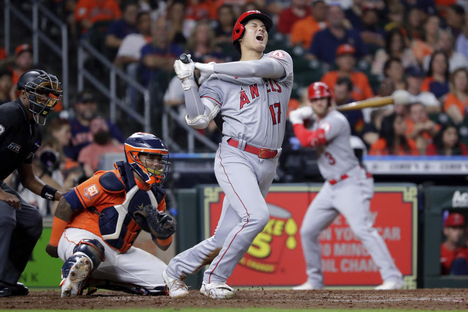 Los Angeles Angels designated hitter Shohei Ohtani (17) reacts after hitting a foul ball in front of Houston Astros catcher Martin Maldonado, center, and umpire Ramon DeJesus, left, during the sixth inning of a baseball game Friday, Sept. 9, 2022, in Houston. (AP Photo/Michael Wyke)