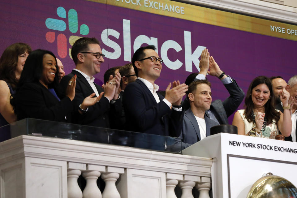 Slack CEO Stewart Butterfield, second from right, is applauded as he rings the New York Stock Exchange opening bell, before his company's IPO, Thursday, June 20, 2019. NYSE President Stacey Cunningham is at right. (AP Photo/Richard Drew)