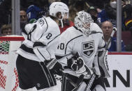 Los Angeles Kings goalie Calvin Petersen (40) is struck on the mask by the puck near teammate Drew Doughty (8) during first-period NHL hockey game action against the Vancouver Canucks in Vancouver, British Columbia, Monday, Dec. 6, 2021. Darryl Dyck/The Canadian Press via AP)