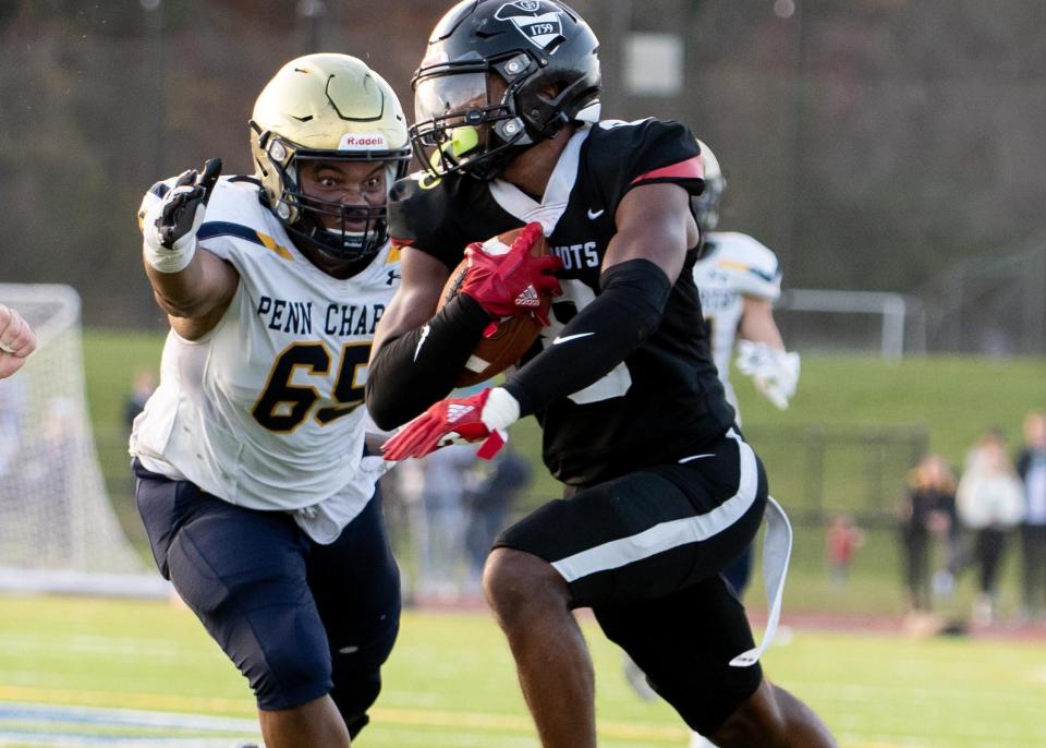 Penn Charter's Clifford Harling attempts to stop Germantown Academy's Evan Spivey, who ran after the catch for a 28-yard gain to the Penn Charter 4-yard line during the Patriots' 28-27 victory Saturday.
