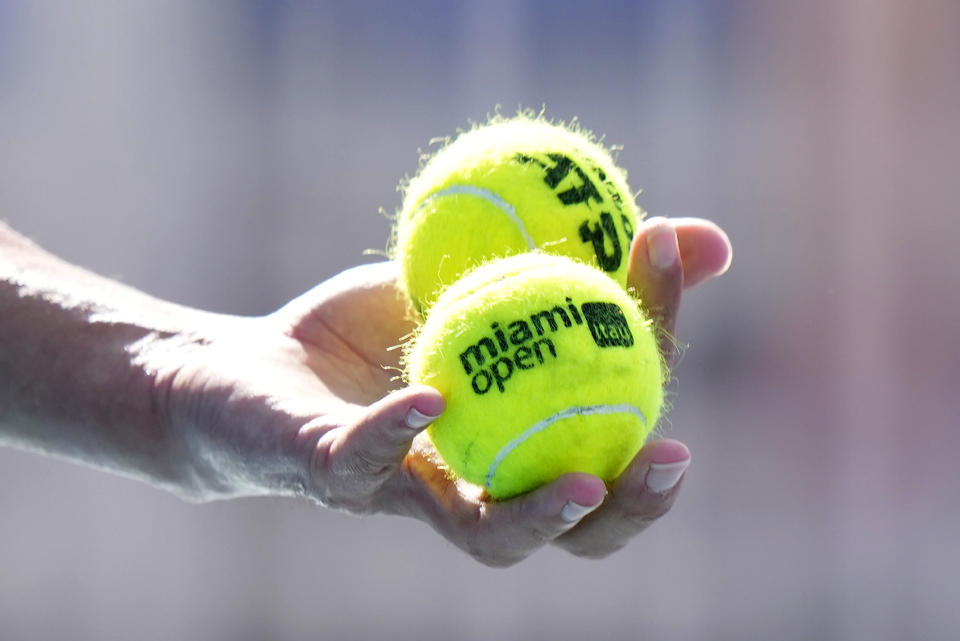 Taro Daniel, of Japan, selects his balls as he prepares to serve Emil Ruusuvuori, of Finland, during the Miami Open tennis tournament, Sunday, March 26, 2023, in Miami Gardens, Fla. (AP Photo/Wilfredo Lee)