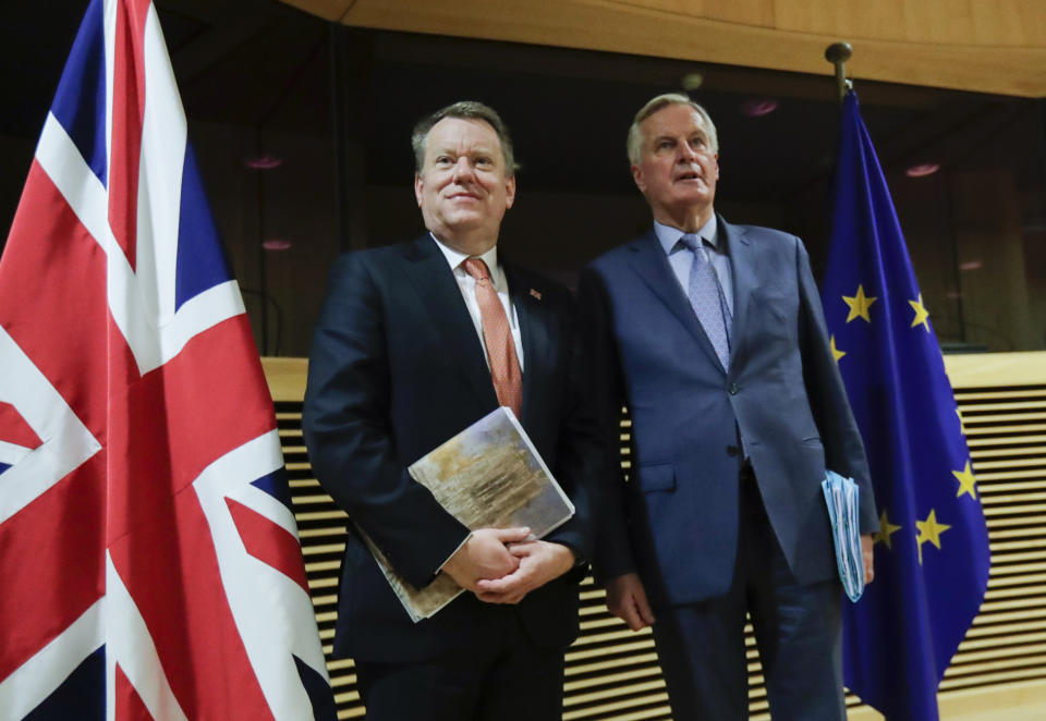 European Union chief Brexit negotiator Michel Barnier, right, speaks with the British Prime Minister's Europe adviser David Frost during the start of the first round of post -Brexit trade talks between the EU and the UK, at EU headquarters in Brussels, Monday, March 2, 2020. Long-awaited trade talks between the EU and Britain kick off Monday amid deep tensions over Prime Minister Boris Johnson's threat to walk away from the talks if not enough progress is made within four months. (Olivier Hoslet. Pool Photo via AP)