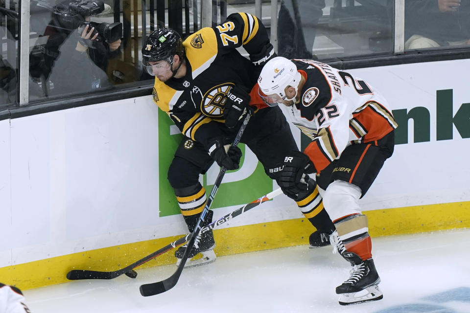 Boston Bruins defenseman Connor Clifton (75) vies for control of the puck with Anaheim Ducks defenseman Kevin Shattenkirk (22) during the second period of an NHL hockey game Thursday, Oct. 20, 2022, in Boston. (AP Photo//Steven Senne)
