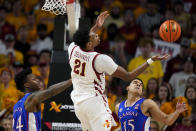 Iowa State center Osun Osunniyi (21) fights for a rebound with Kansas forward K.J. Adams Jr., left, and guard Kevin McCullar Jr., right, during the second half of an NCAA college basketball game, Saturday, Feb. 4, 2023, in Ames, Iowa. Iowa State won 68-53. (AP Photo/Charlie Neibergall)