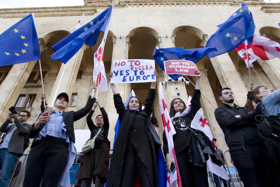 Protestors gather outside the parliament building in Tbilisi, Georgia, on Monday, April 15, 2024, to protest against the "the Russian law" similar to a law that Russia uses to stigmatize independent news media and organizations seen as being at odds with the Kremlin. (AP Photo/Shakh Aivazov)