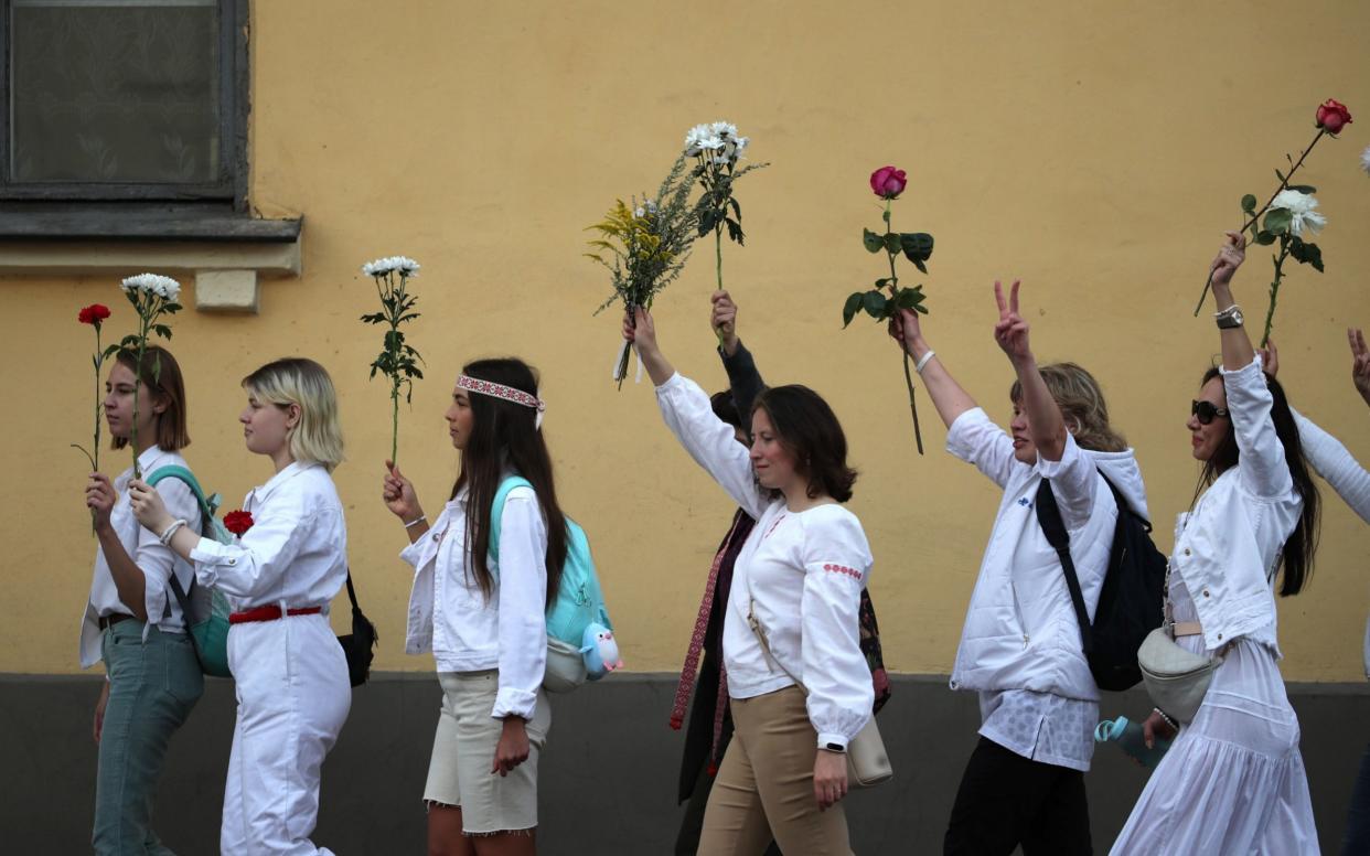 Women holding flowers rallied in support of protesters detained and injured following the disputed election - Tatyana Zenkovich/EPA-EFE