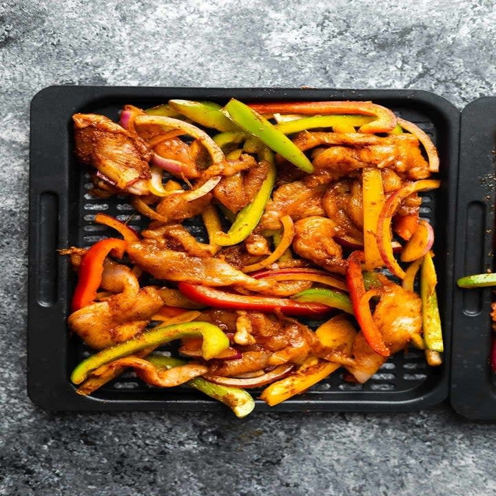 Chicken and vegetables going into the air fryer.