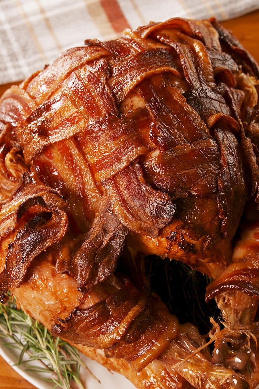 <p>Turkey is great and all, but we just felt it was missing a little something. Bacon was the obvious answer. Crunchy and not an ounce of dryness, this is the turkey you've been looking for. </p><p>Get the <a href="https://www.delish.com/uk/cooking/recipes/a29709014/bacon-wrapped-turkey-recipe/" rel="nofollow noopener" target="_blank" data-ylk="slk:Bacon-Wrapped Turkey;elm:context_link;itc:0;sec:content-canvas" class="link ">Bacon-Wrapped Turkey</a> recipe.</p>