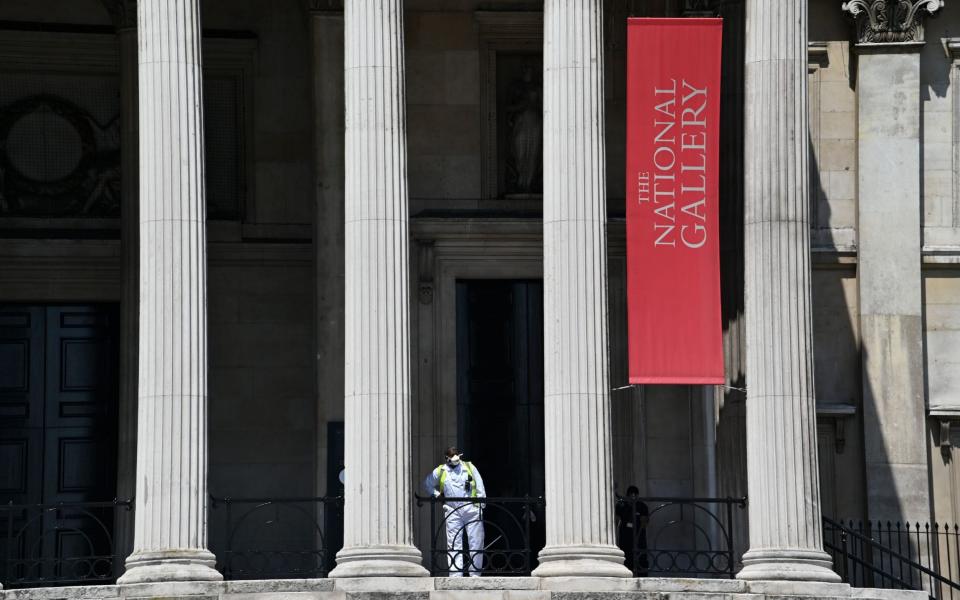 A lone worker in a face mask outside The National Gallery - Justin Tallis/AFP