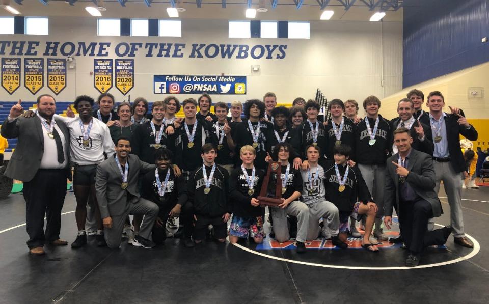 The Jensen High School wrestling team and coaches pose after winning the FHSAA State Dual Championships Saturday in Kissimmee.