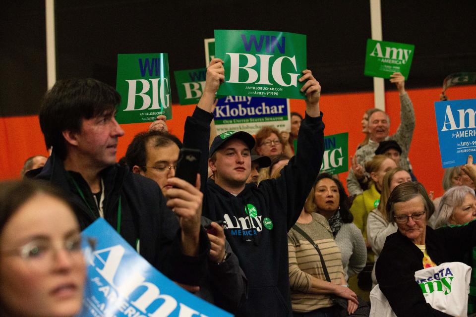 Disapointed supporters hold signs as they face off with protestors who took over the stage forcing Democratic presidential hopeful Minnesota Senator Amy Klobuchar to cancel her rally before it even started on March 1, 2020 in St. Louis Park, west of Minneapolis, Minnesota. - Hundreds of Klobuchar supporters witnessed a group of Black Lives Matter protesters demanding her to drop out of the race after her misshandling of Myon Burrell's case in 2002 when she was County Attorney. (Photo by Kerem Yucel / AFP) (Photo by KEREM YUCEL/AFP via Getty Images)