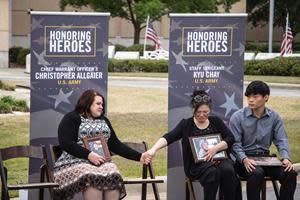 Jennifer Allgaier comforts Cathy Chay during the Tunnel to Towers ceremony honoring their husbands, Army Chief Warrant Officer 3 Christopher Allgaier and Army Staff Sergeant Kyu Chay at the U.S. Army Airborne & Special Operations Museum, in Fayetteville, North Carolina.