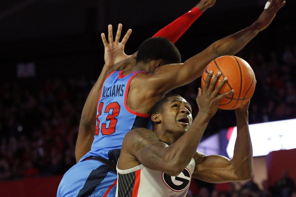 Mississippi guard Bryce Williams (13) blocks a shot from Georgia's Jordan Harris (2) during an NCAA college basketball game in Athens, Ga., Saturday, Jan. 25, 2020. (Joshua L. Jones/Athens Banner-Herald via AP)