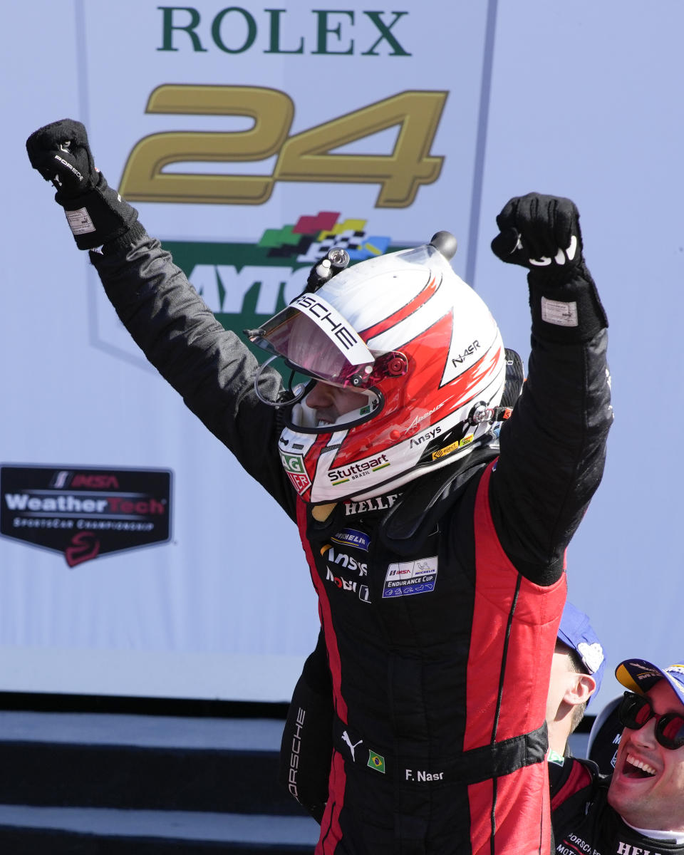 Felipe Nasr celebrates with the Porsche Penske Motorsport team in Victory Lane after winning the Rolex 24 hour auto race at Daytona International Speedway, Sunday, Jan. 28, 2024, in Daytona Beach, Fla. (AP Photo/John Raoux)