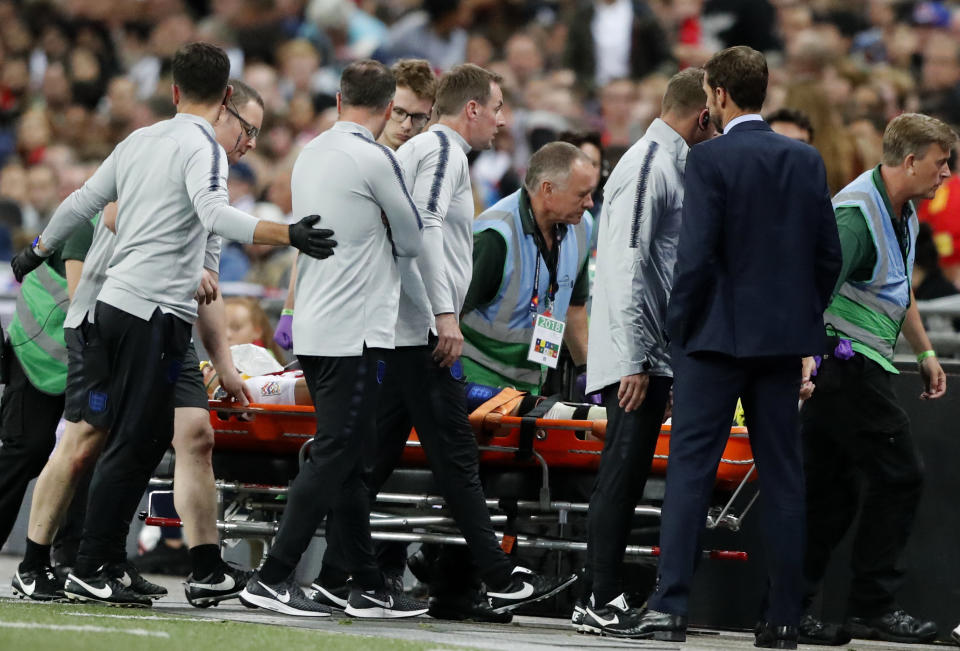 England manager Gareth Southgate, foreground right, watches as England's Luke Shaw is carried off the pitch on a stretcher after he injured himself during the UEFA Nations League soccer match between England and Spain at Wembley stadium in London, Saturday Sept. 8, 2018. (AP Photo/Frank Augstein)