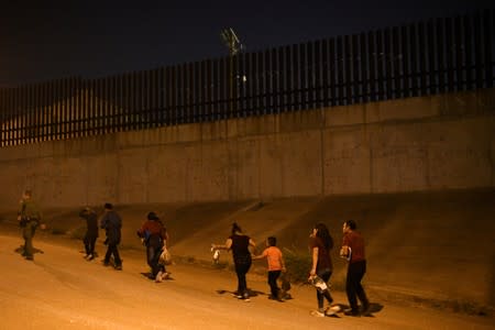 FILE PHOTO: Migrant families turn themselves to U.S. Border Patrol to seek asylum following an illegal crossing of the Rio Grande in Hidalgo