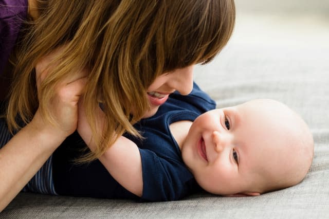 Mother and baby son face to face