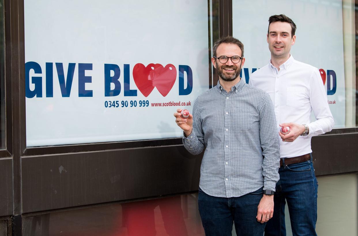 Married couple Steven Smillie and Tyler McNeil mark the changes to blood donation rules at Edinburgh Donor Centre in Scotland (PA)
