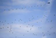 Members of the Special Warfare Command parachute out of a South Korean Air Force CN-235 transport plane during celebrations to mark the 65th anniversary of Korea Armed Forces Day, at a military airport in Seongnam, south of Seoul, October 1, 2013. (REUTERS/Kim Hong-Ji)