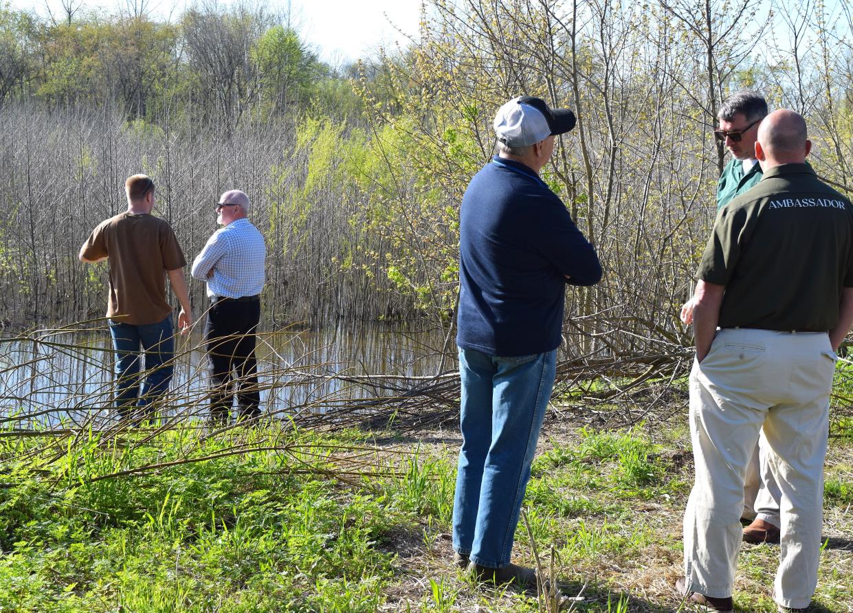 Matt Chanay of the county Engineer's Office chats with Park District board member Dan Mathie while Eric Strouse visits with John Navarro, Ohio Department of Natural Resources, at the ribbon cutting celebrating the Killbuck Creek and Sand Run wetland project on the Holmes County Trail.