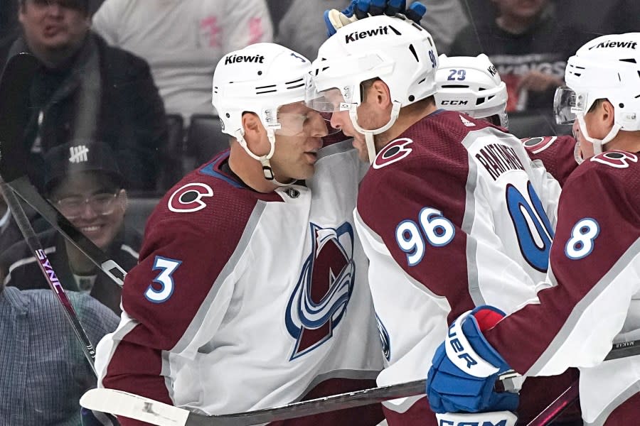 Colorado Avalanche right wing Mikko Rantanen, center, celebrates his goal with defenseman Jack Johnson, left, during the third period of an NHL hockey game against the Los Angeles Kings Wednesday, Oct. 11, 2023, in Los Angeles. (AP Photo/Mark J. Terrill)