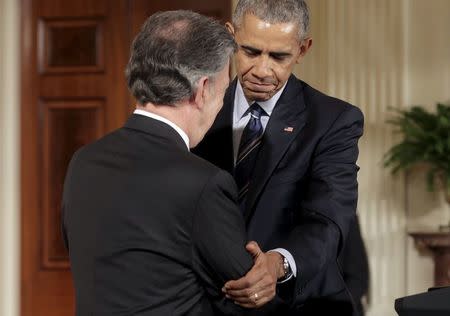 U.S. President Barack Obama shakes hands with President Juan Manuel Santos of Colombia during a reception in the East Room of the White House in Washington February 4, 2016. REUTERS/Joshua Roberts