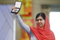 Nobel Peace Prize laureate Malala Yousafzai poses with her medal during the Nobel Peace Prize awards ceremony at the City Hall in Oslo December 10, 2014. Pakistani teenager Malala Yousafzai, shot by the Taliban for refusing to quit school, and Indian activist Kailash Satyarthi received their Nobel Peace Prizes on Wednesday after two days of celebration honouring their work for children's rights. REUTERS/Cornelius Poppe/NTB Scanpix/Pool (NORWAY - Tags: SOCIETY CIVIL UNREST TPX IMAGES OF THE DAY) NORWAY OUT. NO COMMERCIAL OR EDITORIAL SALES IN NORWAY.