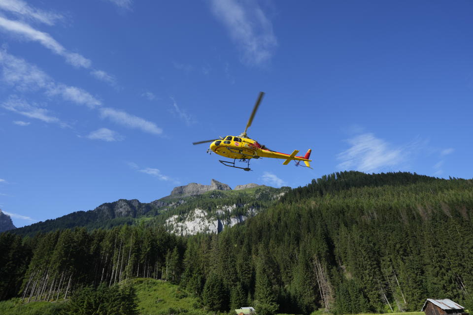 A rescue helicopter takes off to conduct searches for the victims of the Punta Rocca glacier avalanche in Canazei, in the Italian Alps in northern Italy, Tuesday, July 5, 2022, two day after a huge chunk of the glacier broke loose, sending an avalanche of ice, snow, and rocks onto hikers. (AP Photo/Luca Bruno)