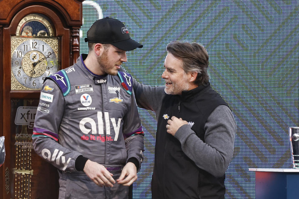 Alex Bowman, left, is congratulated by Jeff Gordon after winning a NASCAR Cup Series auto race, Sunday, Oct. 31, 2021, in Martinsville, Va. (AP Photo/Wade Payne)