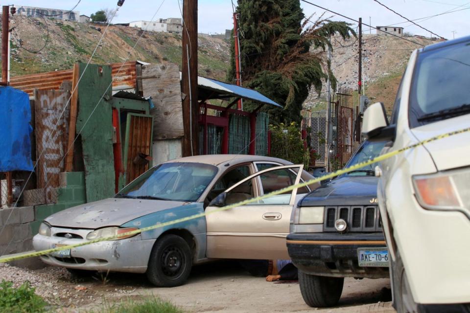 The body of Mexican photojournalist Margarito Martinez Esquivel lies on the ground next to his car after he was killed outside his home, in Tijuana, Mexico (Reuters)