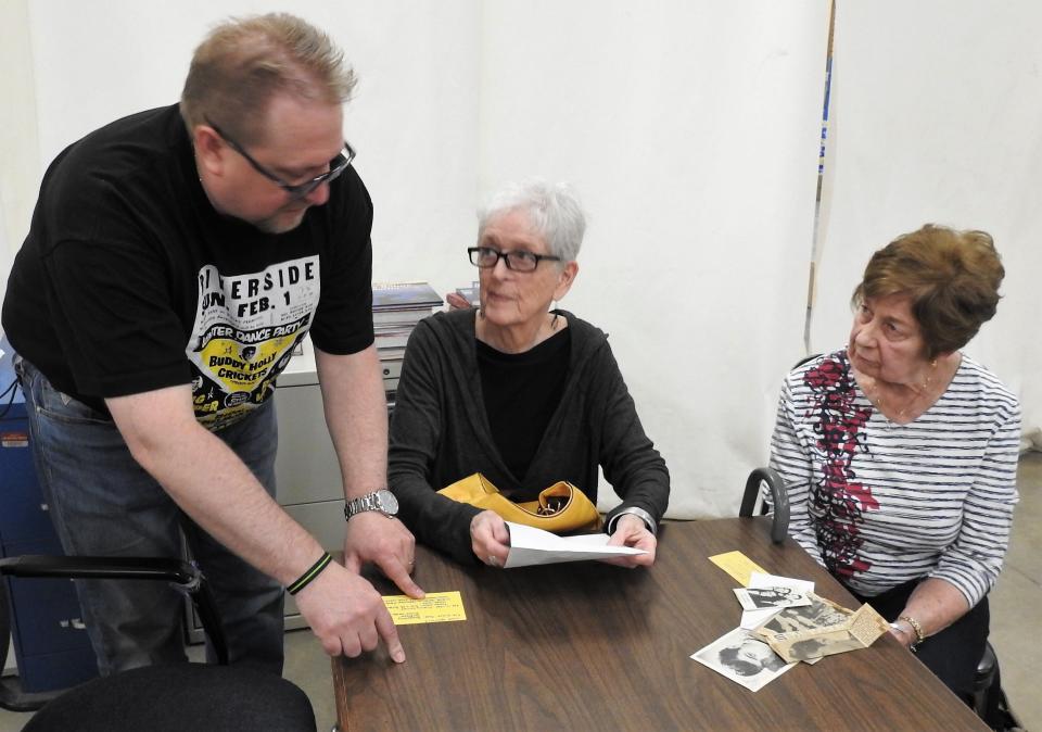 Amateur music historian Dan Heikkinen of Duluth, Minnesota, looks at memorabilia with Carole Cornell and Judy Blair from a concert in February 1959 in Coshocton, part of the Winter Dance Party tour. The show happened about a week after the famed The Day the Music Died tragedy.