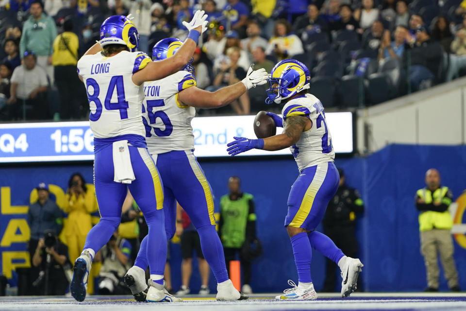 Los Angeles Rams tight end Hunter Long (84) and guard Coleman Shelton (65) celebrate with running back Kyren Williams (23) after Williams scored a touchdown during the second half of an NFL football game against the Cleveland Browns, Sunday, Dec. 3, 2023, in Inglewood, Calif. (AP Photo/Ryan Sun)
