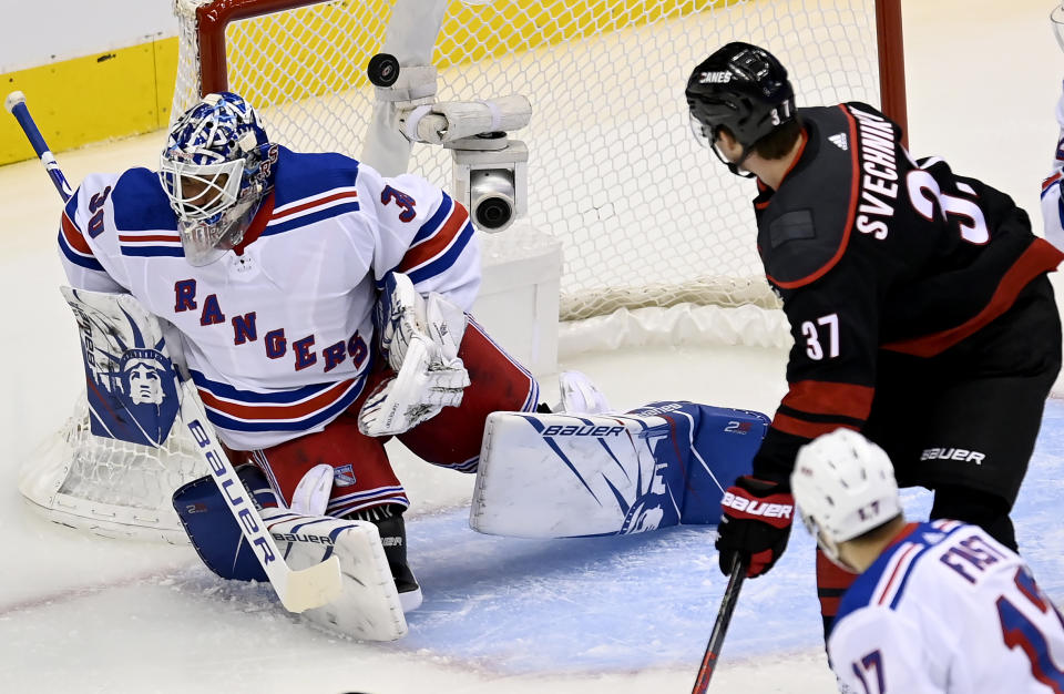 Carolina Hurricanes right wing Andrei Svechnikov (37) watches a goal is scored past New York Rangers goaltender Henrik Lundqvist (30) as Rangers right wing Jesper Fast (17) looks on during the first period in the NHL hockey Stanley Cup playoffs in Toronto, Saturday, Aug. 1, 2020. (Frank Gunn/The Canadian Press via AP)