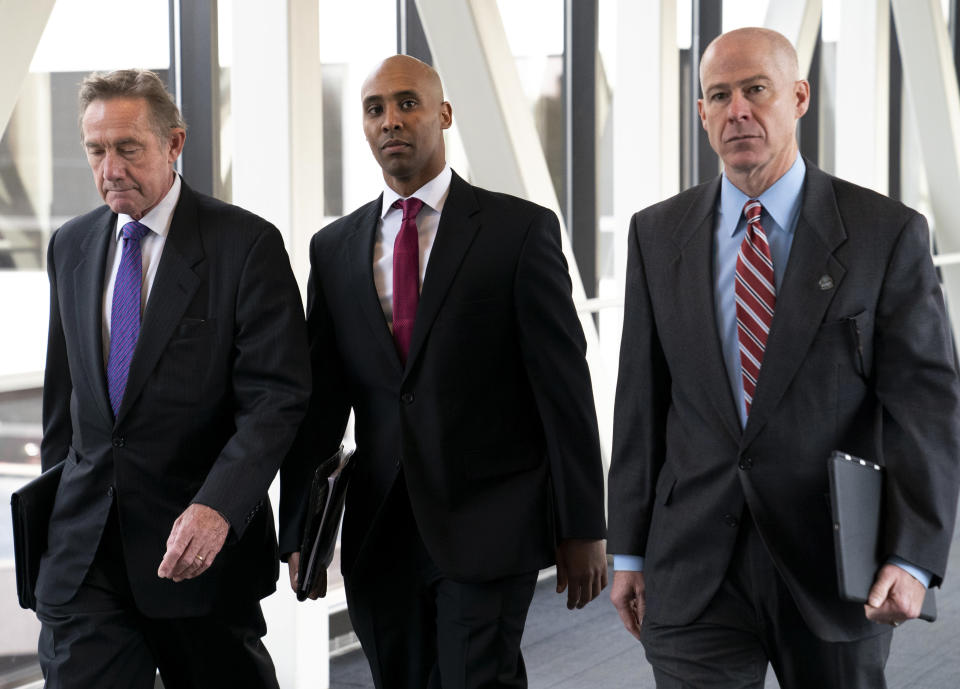 FILE - In this April 1, 2019, file photo, former Minneapolis police officer Mohamed Noor, center, arrives for the first day of jury selection with his attorneys Peter Wold, left, and Thomas Plunkett, at the Hennepin County Government Center in Minneapolis, Minn. Noor is charged in the July 2017 death of Justine Ruszczyk Damond, who was killed after she called 911 to report a possible sexual assault behind her home.(Renee Jones Schneider/Star Tribune via AP, File)