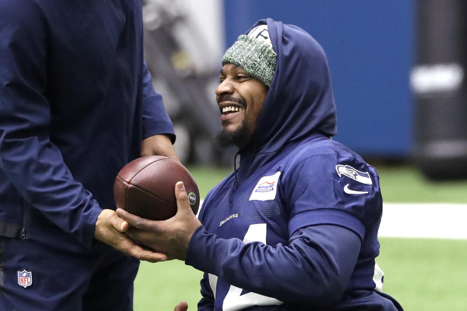 Seattle Seahawks running back Marshawn Lynch smiles during warmups at the NFL football team's practice facility Tuesday, Dec. 24, 2019, in Renton, Wash. When Lynch played his last game for the Seahawks in 2016, the idea of him ever wearing a Seahawks uniform again seemed preposterous. Yet, here are the Seahawks getting ready to have Lynch potentially play a major role Sunday against San Francisco with the NFC West title on the line. (AP Photo/Elaine Thompson)