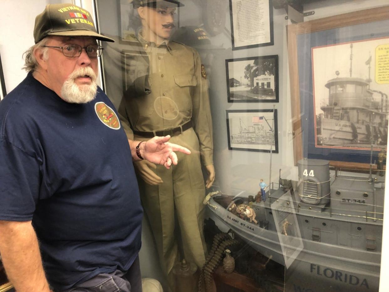Dan Friend, a Vietnam-era veteran from DeLand, points to a model of the World War II-era tugboat he has been working to return to Volusia County from Sweden for about 10 years.