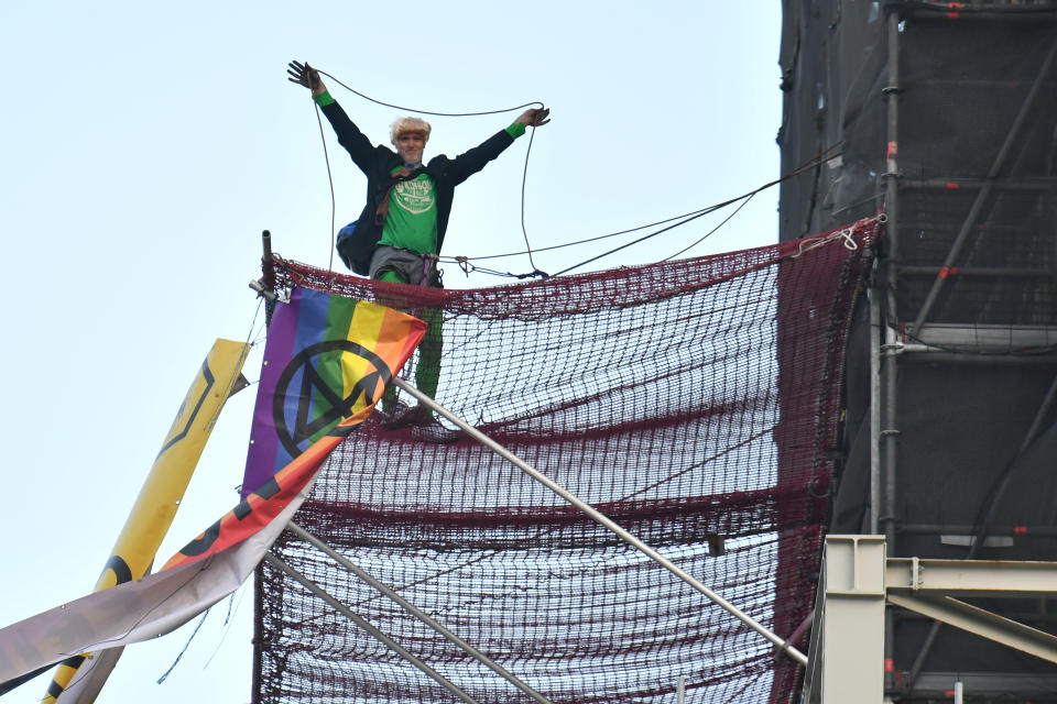 An Extinction Rebellion protester who has scaled the scaffolding surrounding Big Ben at the Houses of Parliament, Westminster, London. (Photo by Dominic Lipinski/PA Images via Getty Images)