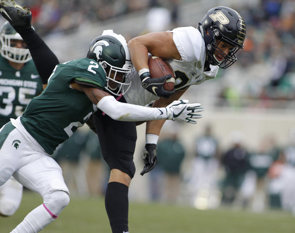 Purdue's Brycen Hopkins, right, is brought down by Michigan State's Justin Layne (2) on a pass reception during the first quarter of an NCAA college football game, Saturday, Oct. 27, 2018, in East Lansing, Mich. (AP Photo/Al Goldis)