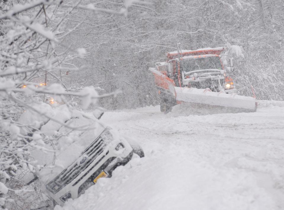 A state plow truck clears snow along Route 30 in Jamaica, Vt., on Dec. 16, 2022.