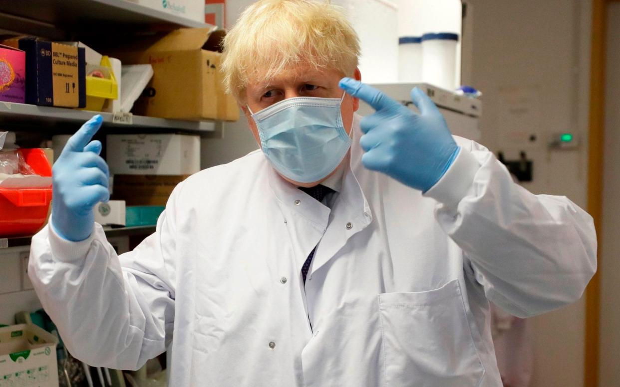 Britain's Prime Minister Boris Johnson gestures during a visit to the Jenner Institute in Oxford, central England, on September 18, 2020. - Millions more people in northern and central England faced new restrictions over a surge in coronavirus cases, the British government announced on Friday, as it warned another national lockdown could be imminent - Kirsty Wigglesworth/AFP via Getty Images