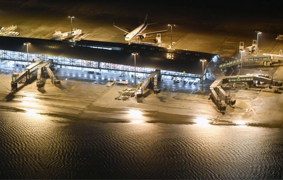 <p> Kansai International Airport partially is flooded by typhoon Jebi in Osaka, western Japan, Tuesday, Sept. 4, 2018. A powerful typhoon blew through western Japan on Tuesday, causing heavy rain to flood the region's main offshore international airport and high winds to blow a tanker into a connecting bridge, disrupting land and air travel. (Nobuki Ito/Kyodo News via AP) </p>