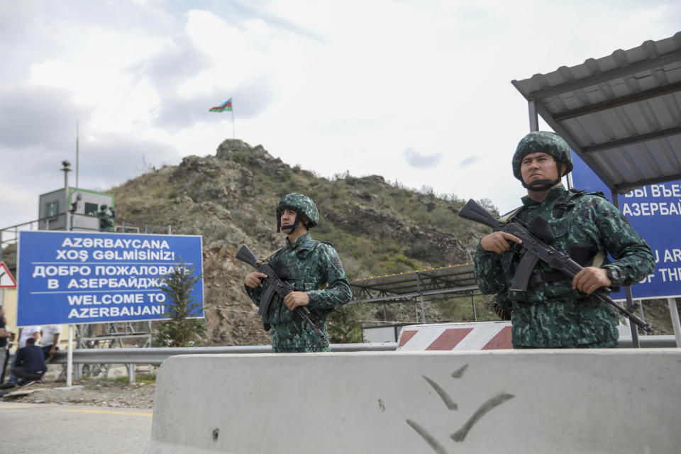 FILE - Azerbaijani servicemen guard the Lachin checkpoint on the in Azerbaijan, Sunday, Oct. 1, 2023. Lawyers for Azerbaijan on Monday urged the top United Nations court to throw out a case filed by Armenia linked to the long-running dispute over the Nagorno-Karabakh region, arguing that judges do not have jurisdiction. (AP Photo/Aziz Karimov, File)