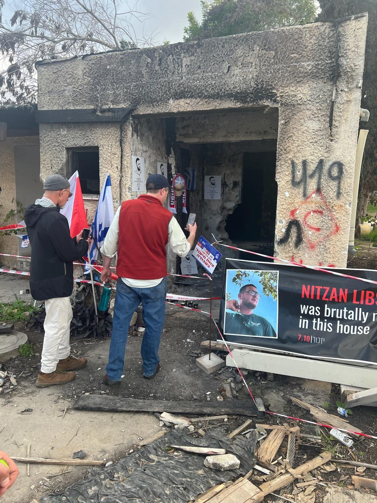 Rabbi Shalom Kantor from Congregation B’nai Moshe (in red vest) in West Bloomfield photographs the home where Nitzan Lipshitz was killed at Kibbutz Kfar Aza, which Hamas fighters attacked on Oct 7. Kantor was one of four rabbis who visited Israel from Jan. 22-24, 2024.