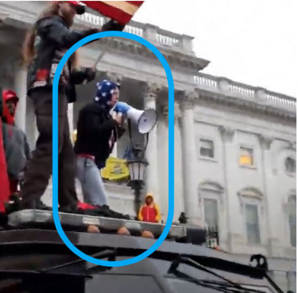 Tanya Bishop of Greene County, North Carolina, stands on top of a police car during the riots at the Capitol on January 6, 2021. She faces felony and misdemeanor charges after being at the Capitol that day as part of an FBI investigation.