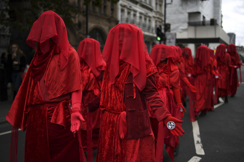 Climate activists take part in a demonstration at Whitehall, in London, Monday, Oct. 7, 2019. London Police say they've arrested 21 climate change activists over the past few days as the Extinction Rebellion group attempts to draw attention to global warming. (AP Photo/Alberto Pezzali)